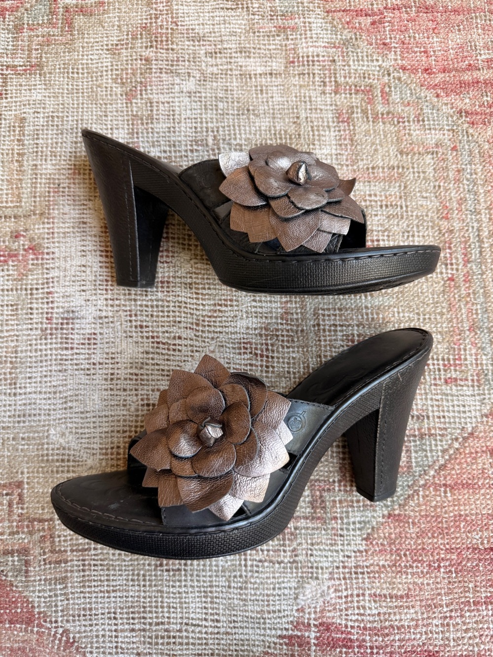 Born Black Heeled Mules with Metallic Bronze Floral Accent